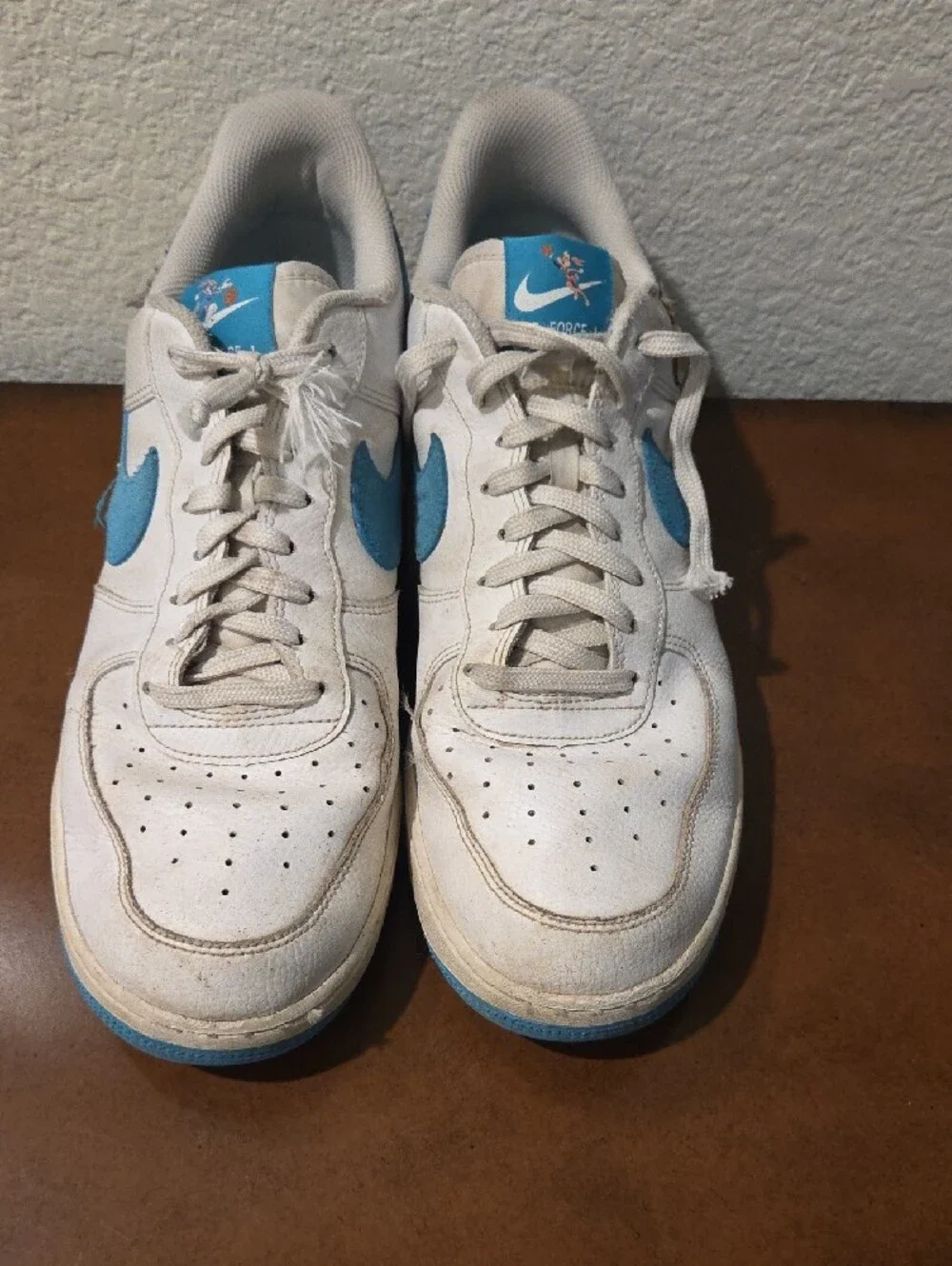 Nike AIR FORCE 1 White and Light Blue Low-Top Sneakers with Cartoon Graphic